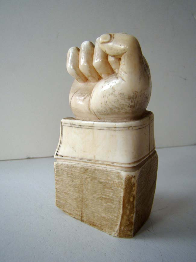 A fine and RARE carved Whale Tooth Paperweight in the form of a fist with cuff circa 1850